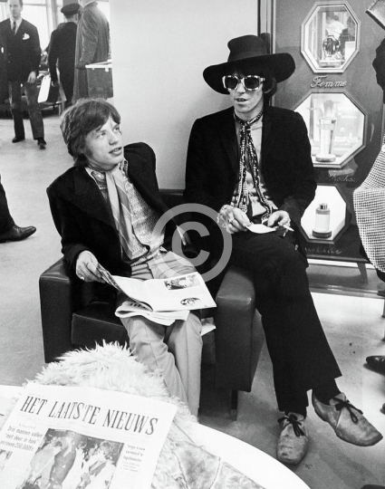 Mick Jagger And Keith Richards Candid With Newspaper